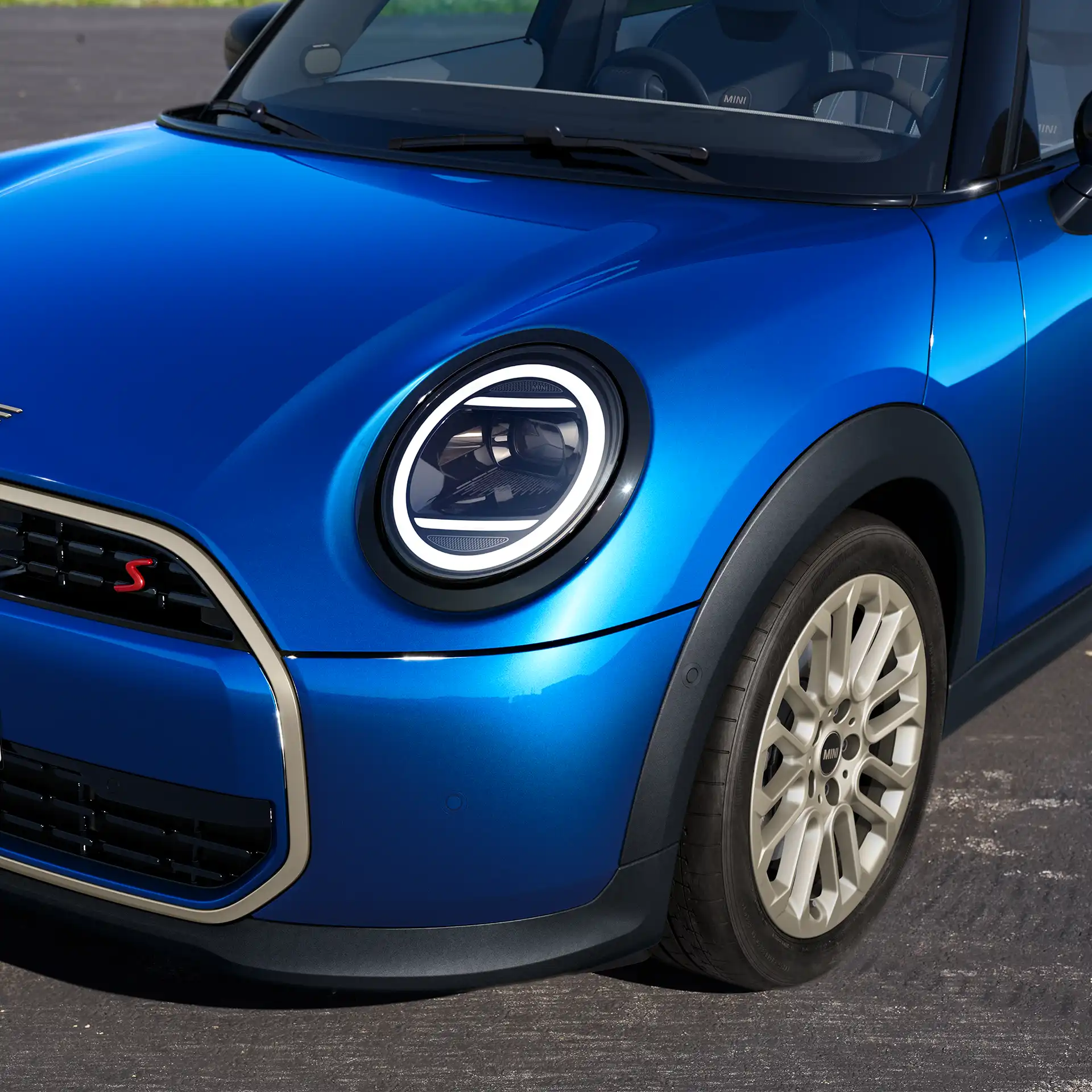 Front detail view of the MINI Cooper 5-Door showing design elements, the headlights, and the rims