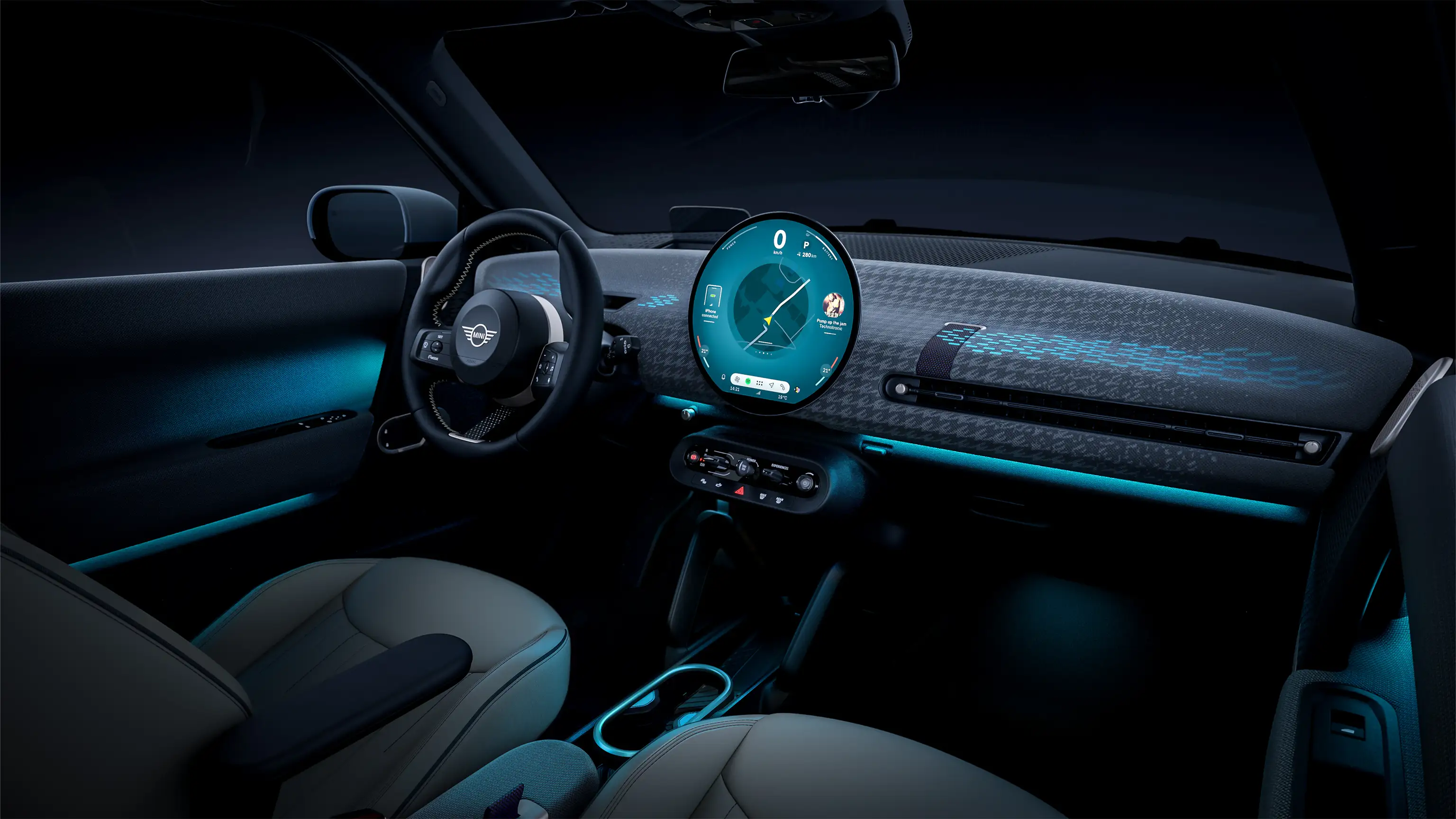 Panoramic view of the illuminated dashboard of the all-electric MINI Cooper