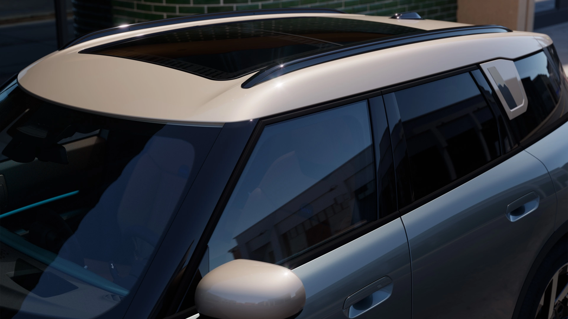 Top view of the MINI Countryman in Smokey Green with with contrast roof and big glass roof.