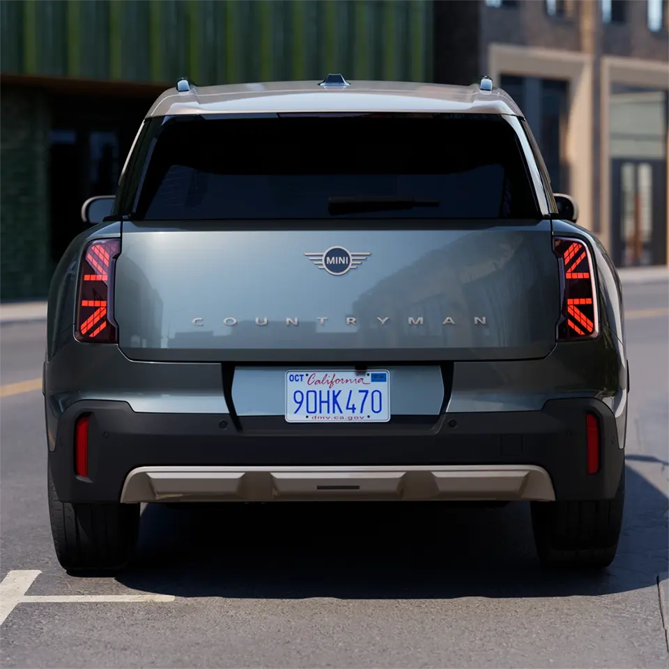 Rear view of a parking MINI Countryman in Smokey Green with Vibrant Silver Roof